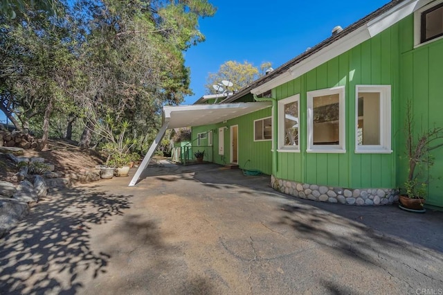 view of home's exterior featuring aphalt driveway and a carport