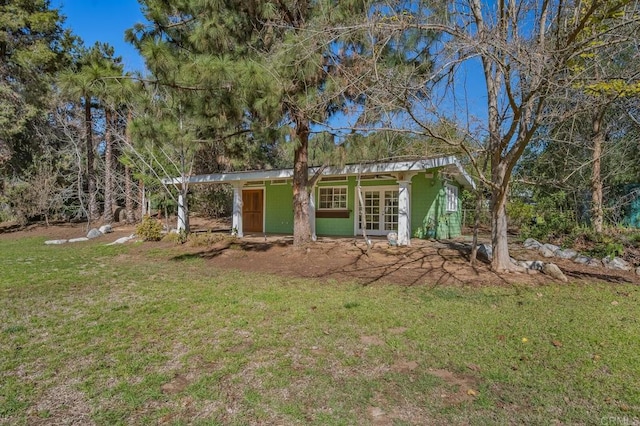 view of home's exterior with french doors and a yard