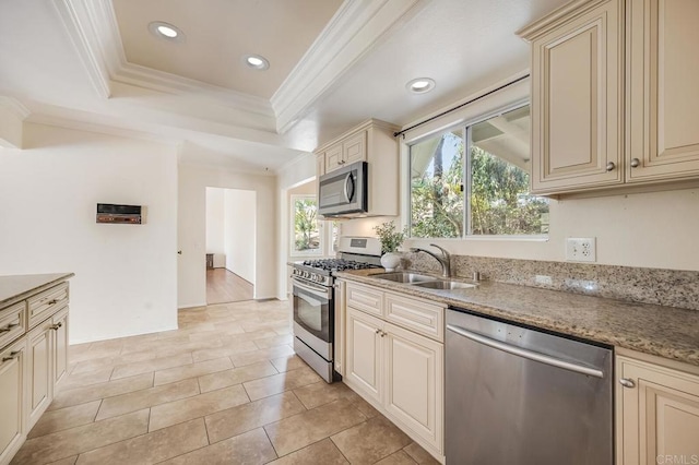 kitchen with a sink, appliances with stainless steel finishes, and cream cabinets