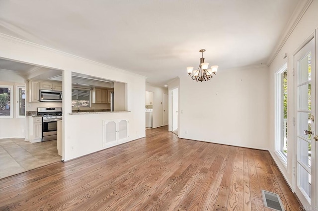 interior space featuring ornamental molding, visible vents, and an inviting chandelier