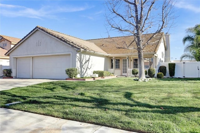 view of front of house with concrete driveway, a tiled roof, an attached garage, a front yard, and stucco siding