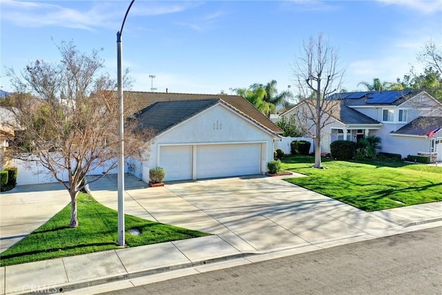 view of front of house with stucco siding, concrete driveway, an attached garage, a front yard, and a tiled roof