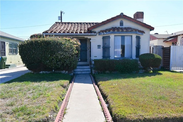 view of front of property featuring a front yard, fence, and a chimney