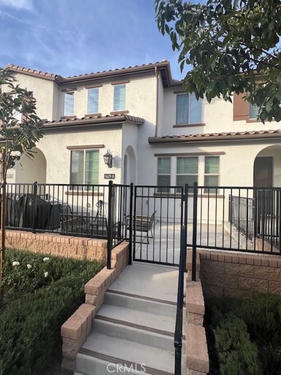 exterior space featuring a fenced front yard, a gate, and stucco siding