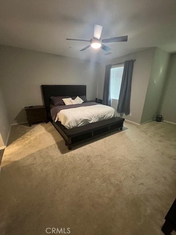 bedroom featuring carpet, baseboards, and ceiling fan