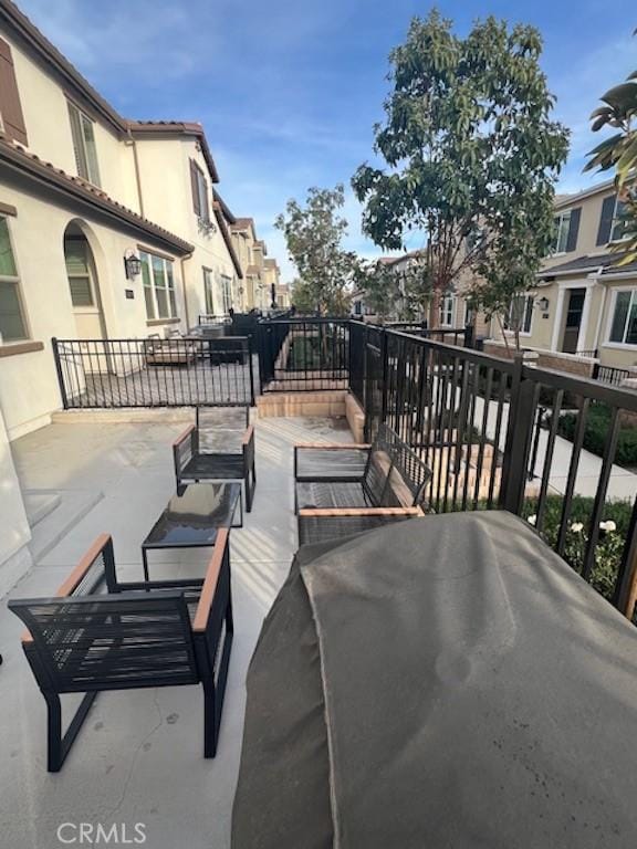 view of patio / terrace featuring a residential view, an outdoor living space, and grilling area