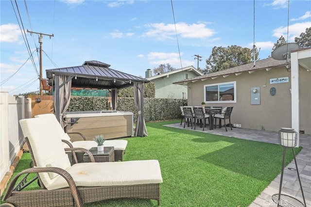 view of yard featuring a patio area, a fenced backyard, a hot tub, and a gazebo