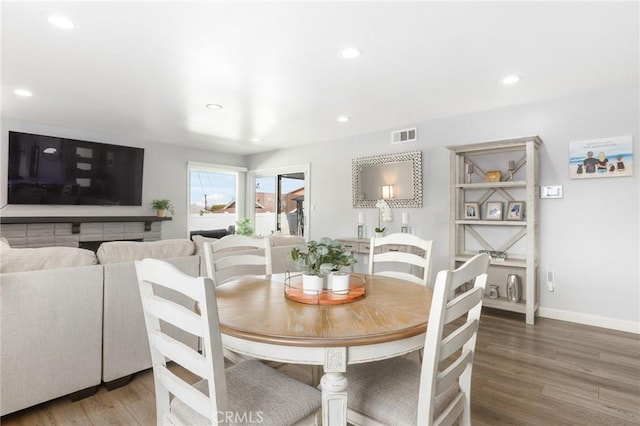 dining space featuring visible vents, baseboards, wood finished floors, and recessed lighting