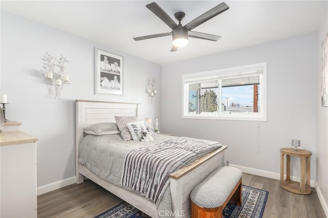 bedroom featuring wood finished floors, a ceiling fan, and baseboards