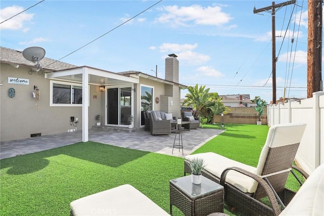 rear view of property featuring a patio, a fenced backyard, an outdoor living space, a yard, and a chimney