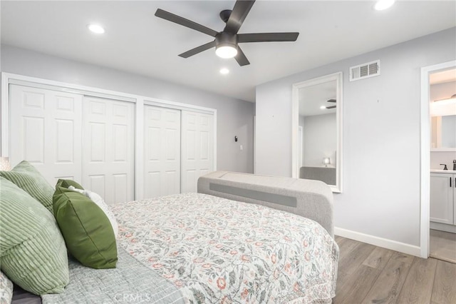 bedroom featuring recessed lighting, visible vents, baseboards, multiple closets, and light wood-type flooring