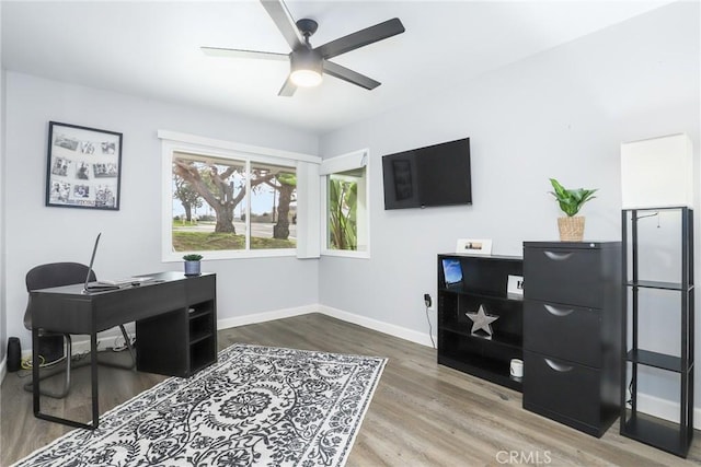 home office with ceiling fan, baseboards, and wood finished floors
