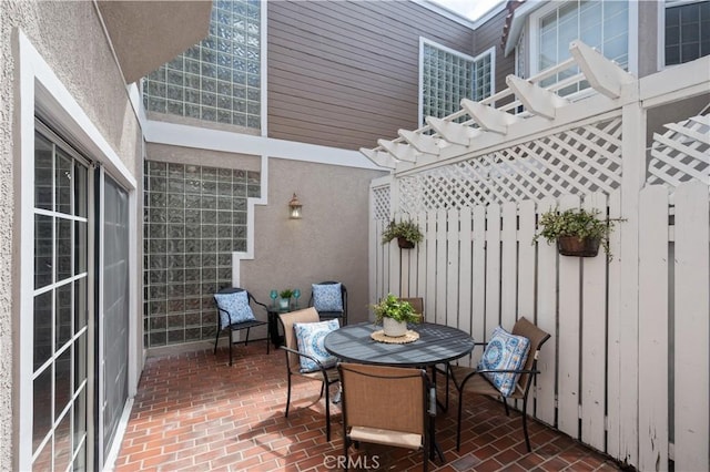 view of patio / terrace with outdoor dining space and a pergola