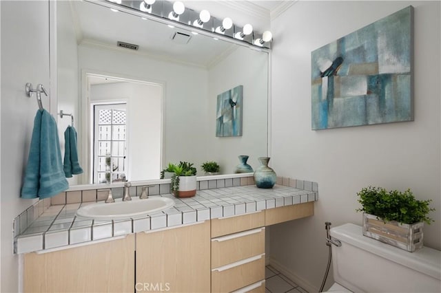 bathroom featuring toilet, visible vents, ornamental molding, and vanity