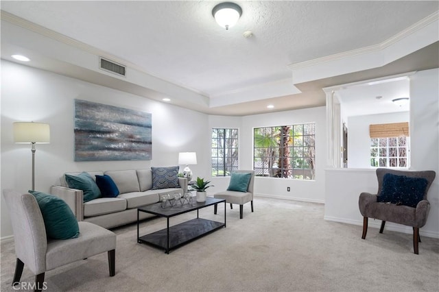 living room featuring ornamental molding, visible vents, light carpet, and baseboards