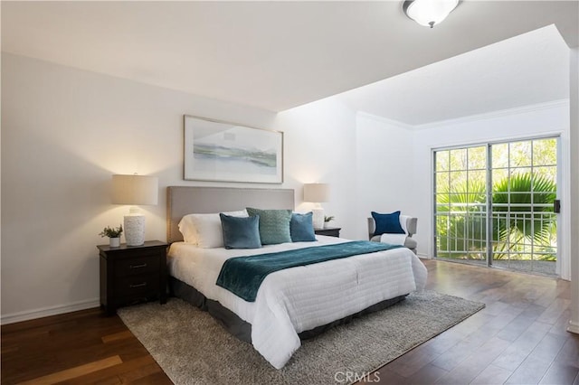 bedroom with access to exterior, dark wood-style flooring, crown molding, and baseboards