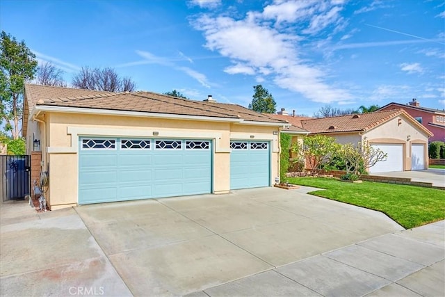 single story home with a garage, a front yard, and stucco siding