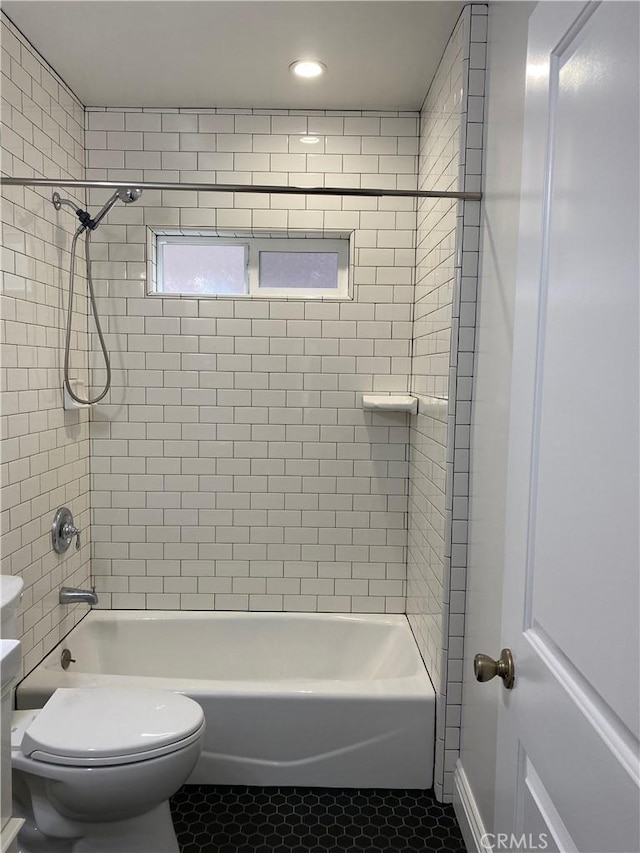 full bathroom featuring tub / shower combination, toilet, and tile patterned floors