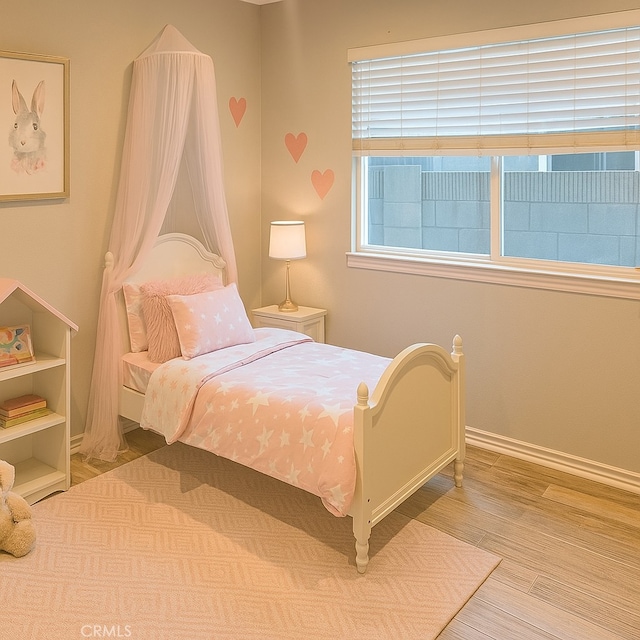 7122 Bluesails Dr, Huntington Beach, CA 92647 - bedroom with wood finished floors and baseboards