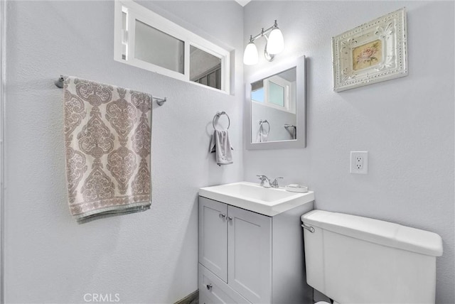 bathroom featuring toilet and vanity