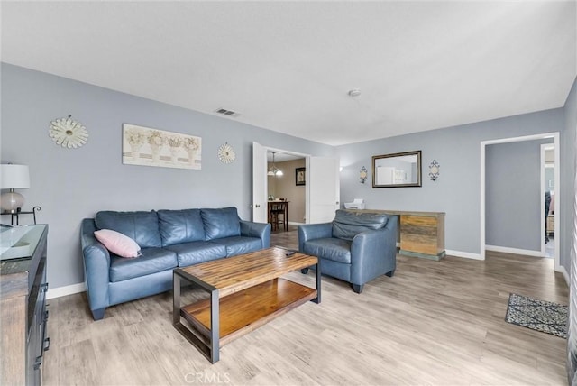 living room featuring light wood-type flooring and baseboards