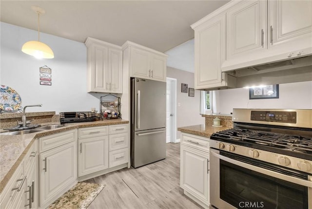 kitchen featuring stainless steel appliances, white cabinetry, a sink, and under cabinet range hood