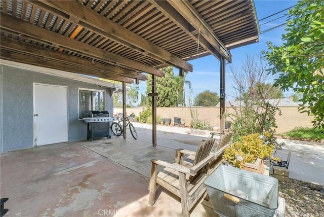 view of patio featuring a fenced backyard, a grill, and a pergola