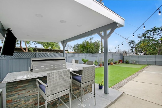 view of patio / terrace with a fenced backyard and outdoor dry bar