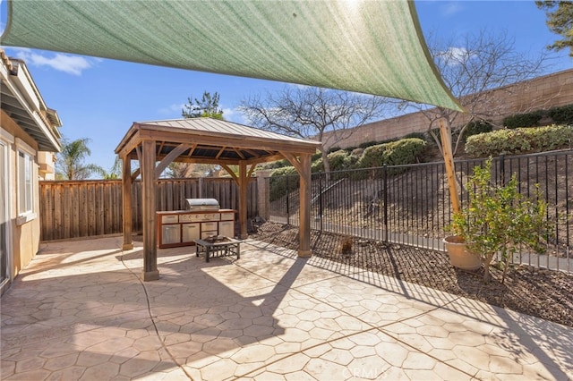 view of patio / terrace featuring a fenced backyard, a fire pit, a gazebo, and grilling area