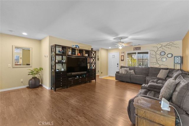 living area with ceiling fan, baseboards, wood finished floors, and recessed lighting