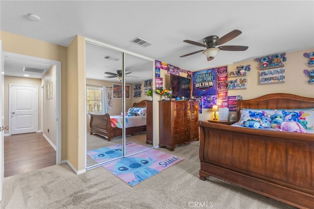 bedroom featuring light colored carpet, a closet, and visible vents