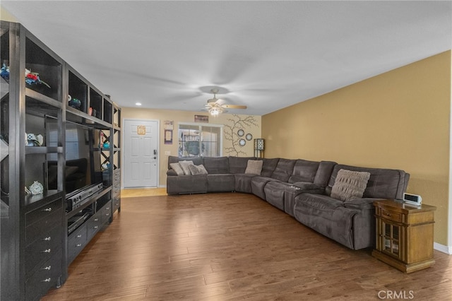 living room featuring dark wood-style floors and ceiling fan