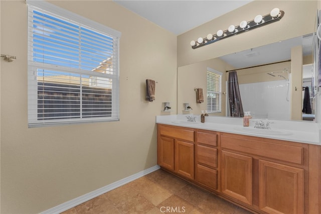 full bathroom featuring double vanity, baseboards, a sink, and a shower with shower curtain