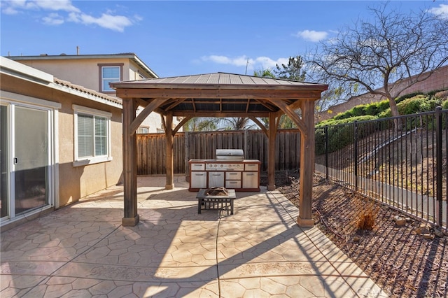 view of patio / terrace featuring a fire pit, a gazebo, grilling area, and a fenced backyard