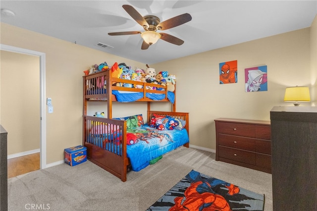 bedroom with light colored carpet, visible vents, ceiling fan, and baseboards