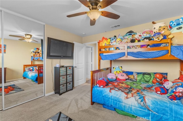 bedroom with ceiling fan, carpet floors, a closet, and visible vents