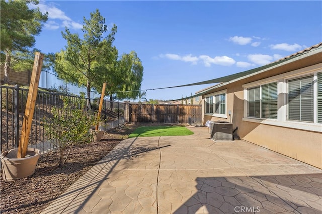 view of patio with a fenced backyard and central air condition unit