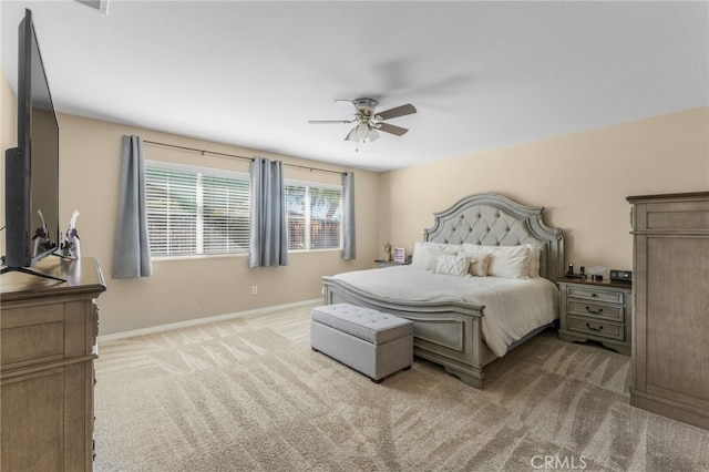 bedroom featuring baseboards, a ceiling fan, and light colored carpet