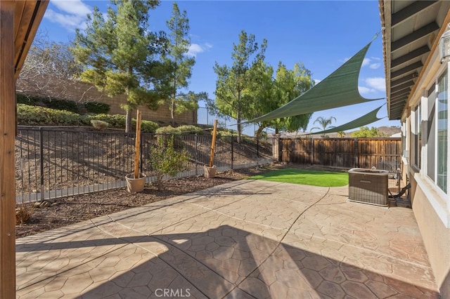 view of patio with a fenced backyard and central AC unit