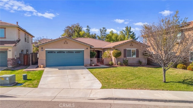 view of front of home featuring driveway, a garage, a tiled roof, a front lawn, and stucco siding