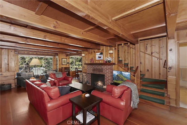 177 Joaquin Miller Rd, Lake Arrowhead, CA 92352 - living area with wooden walls, hardwood / wood-style floors, stairway, beam ceiling, and a brick fireplace