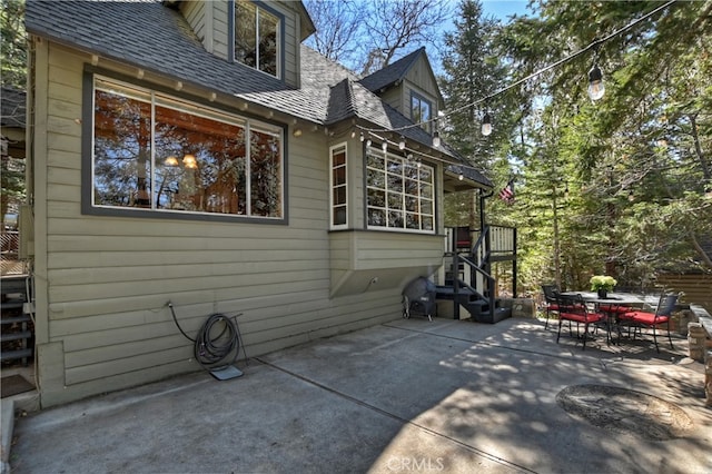 177 Joaquin Miller Rd, Lake Arrowhead, CA 92352 - view of home's exterior featuring a patio area, roof with shingles, and outdoor dining space