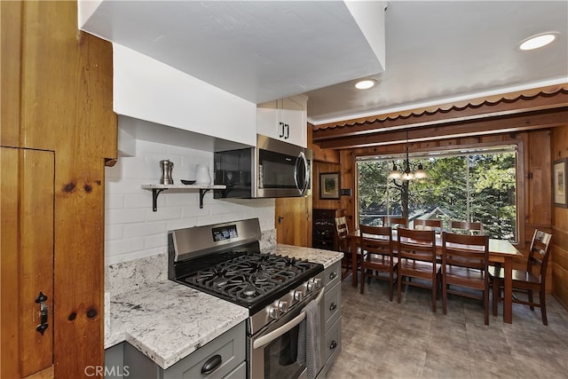 177 Joaquin Miller Rd, Lake Arrowhead, CA 92352 - kitchen with appliances with stainless steel finishes, open shelves, light stone countertops, a chandelier, and decorative backsplash