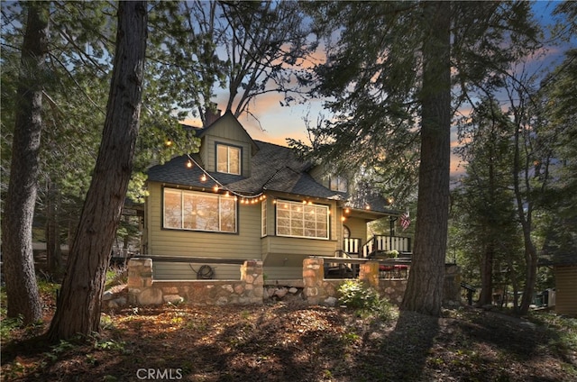 177 Joaquin Miller Rd, Lake Arrowhead, CA 92352 - back of house at dusk featuring roof with shingles