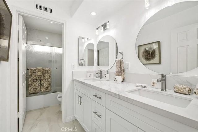 bathroom with toilet, a sink, visible vents, marble finish floor, and combined bath / shower with glass door