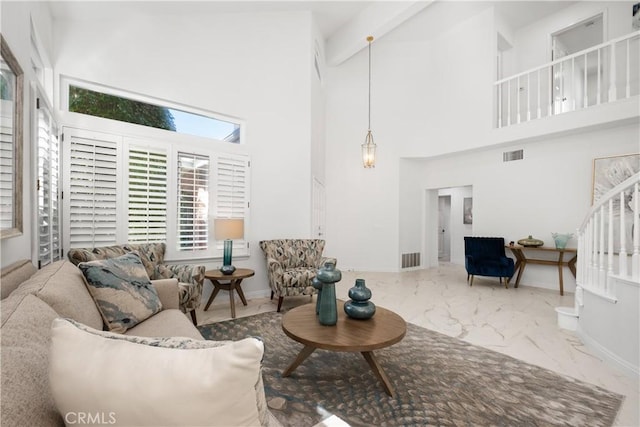 living area with marble finish floor, stairway, visible vents, and baseboards