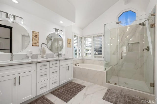 full bath featuring vaulted ceiling, a sink, a marble finish shower, and double vanity