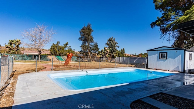 view of pool with an outdoor structure, fence, and a fenced in pool