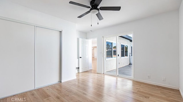 unfurnished bedroom with access to exterior, light wood finished floors, a closet, ceiling fan, and baseboards