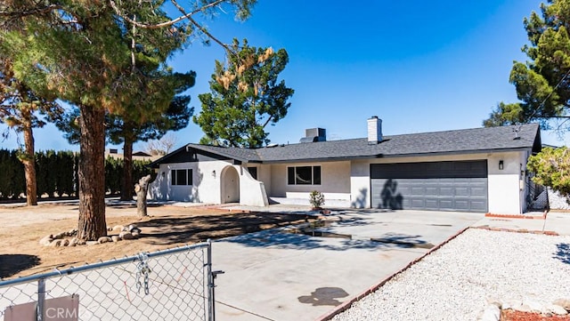 ranch-style house featuring driveway, a garage, a chimney, fence, and stucco siding